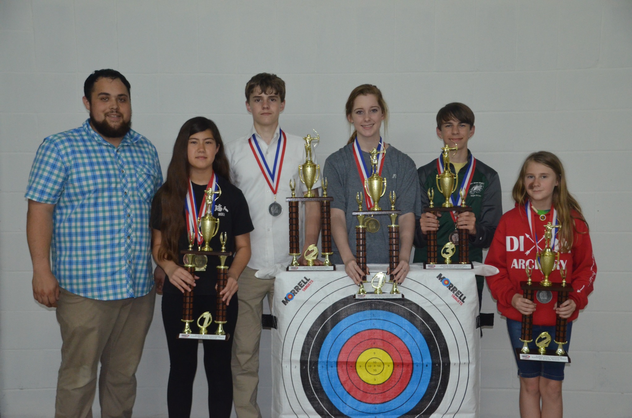 Coach Joshua Clarke with five archers at the 2019 Alabama State Championship