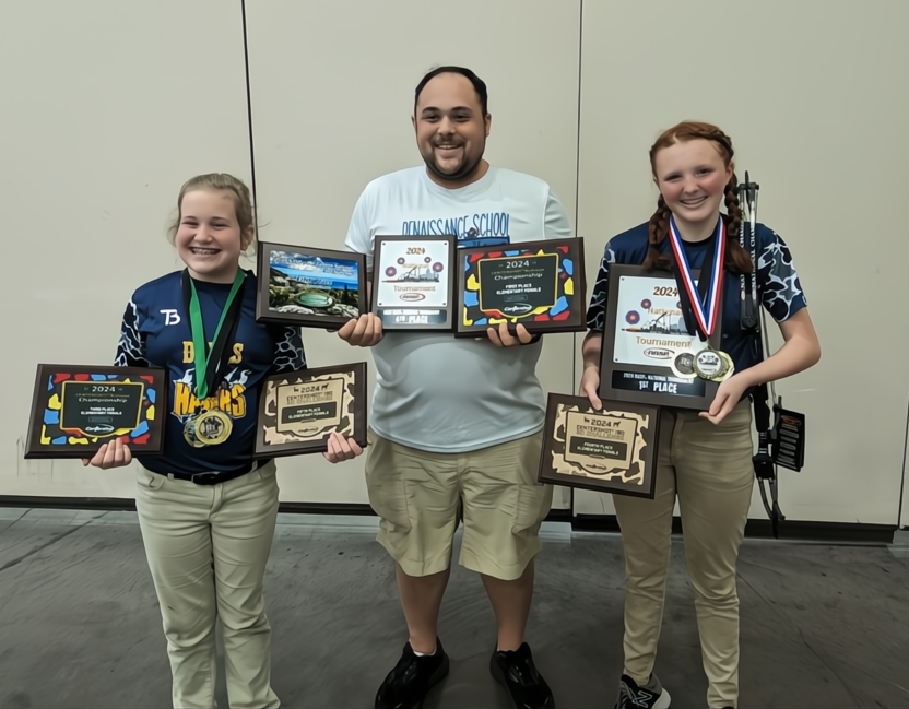 Coach Joshua Clarke with Lilliana Smith and Makynzie Thompson celebrating 2024 tournament achievements