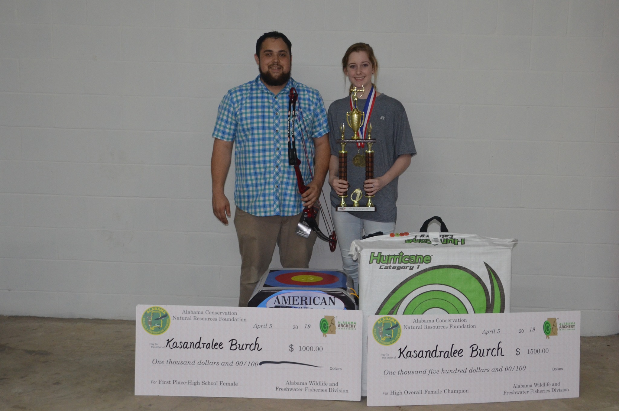 Coach Joshua Clarke with 2019 Alabama State Champion Kasandralee Burch and her scholarship awards