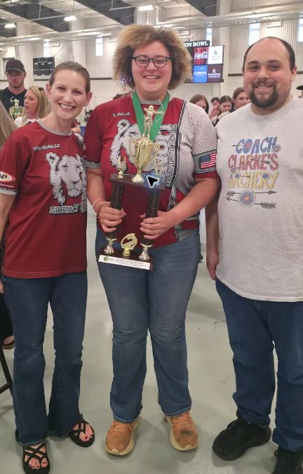 Coach Shelly Kirk, Laila Evans, and Coach Joshua Clarke after Laila’s second-place finish at the 2026 Alabama State Championship