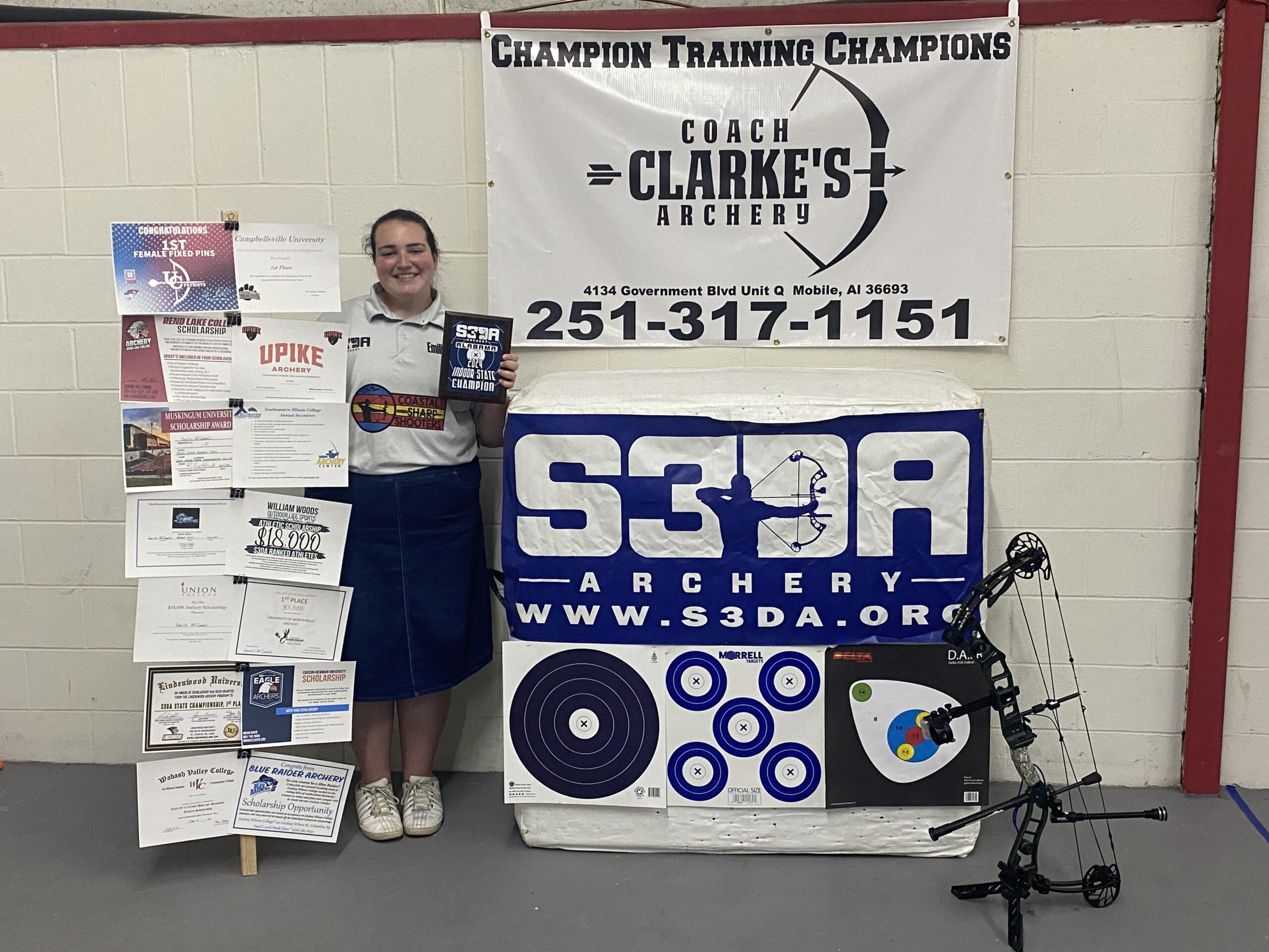 Emilie with her state championship award and scholarship display